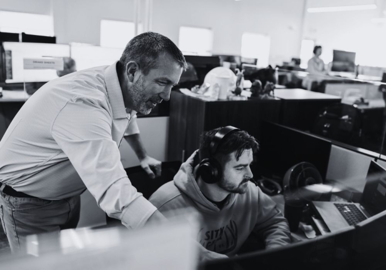 IT professionals working together to support business technology systems