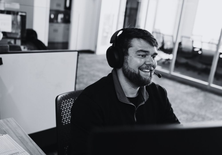 IT support specialist wearing a headset while monitoring business systems