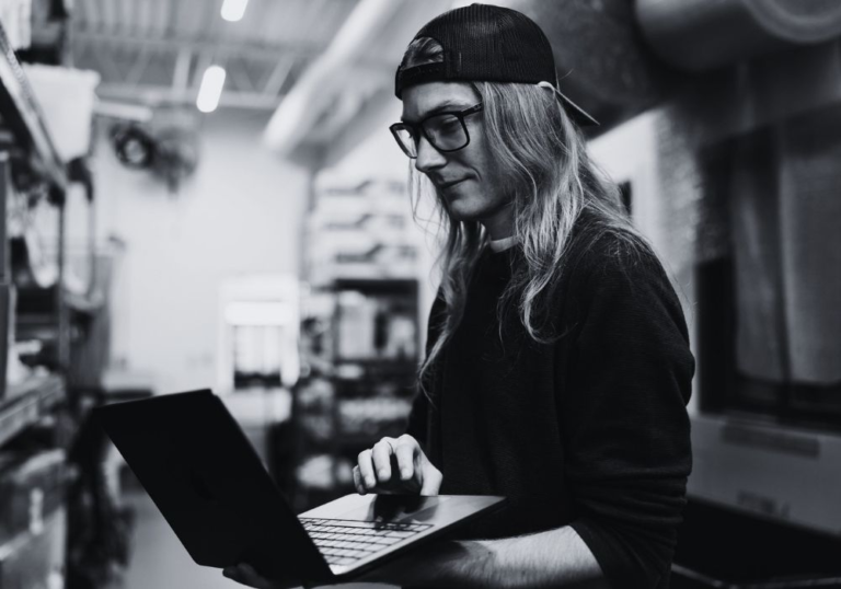 IT technician using a laptop while providing on-site technology support