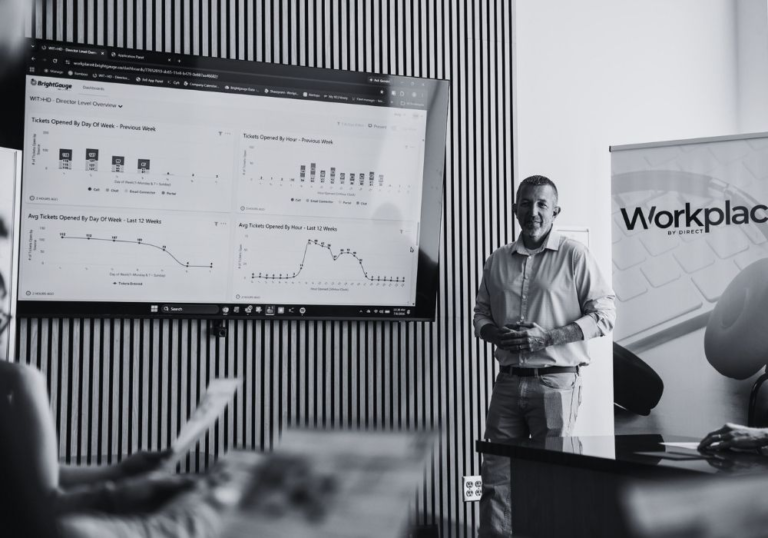 Workplace IT professional presenting technology performance data to a business team