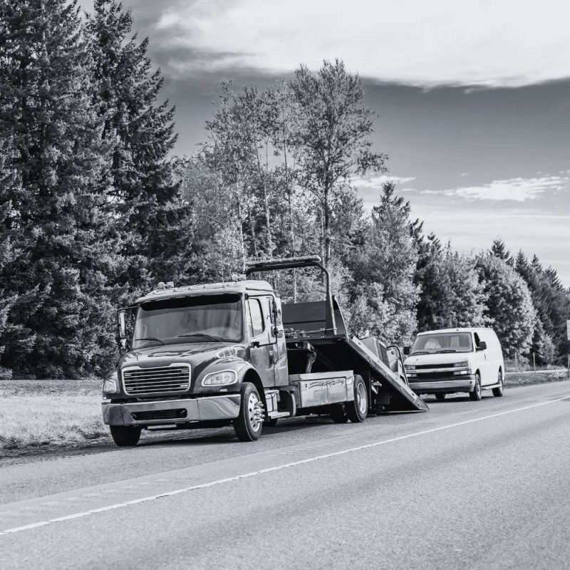Tow truck and service van representing fleet tracking, routing, and mobile workforce management