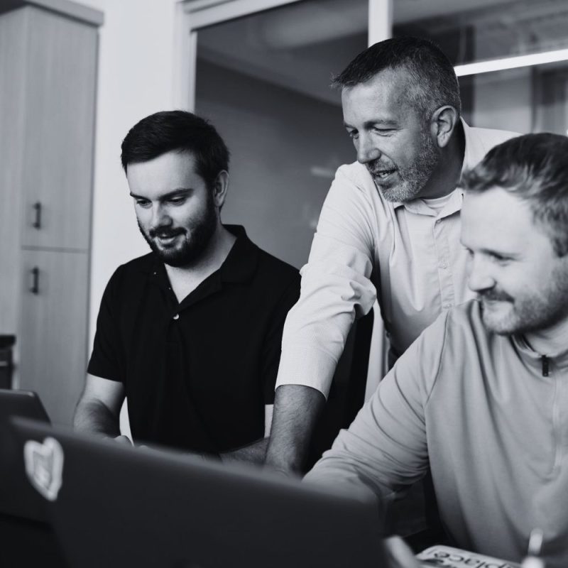 Workplace technology professional discussing IT planning and support during a team meeting.