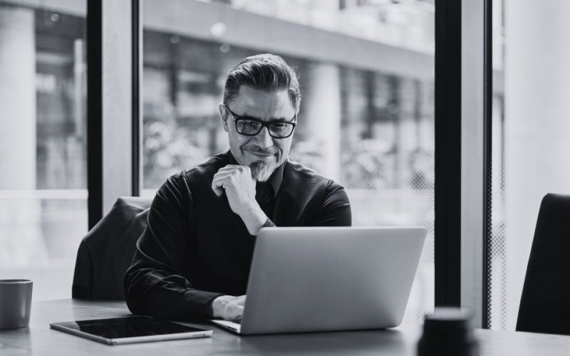 A person working at a computer represents an overwhelmed IT team, that could benefit from Co-managed IT support.