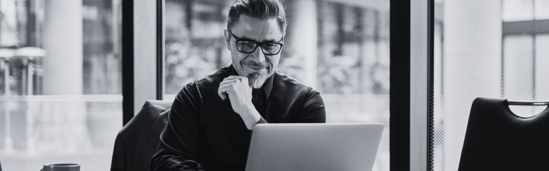 A person working at a computer represents an overwhelmed IT team, that could benefit from Co-managed IT support.